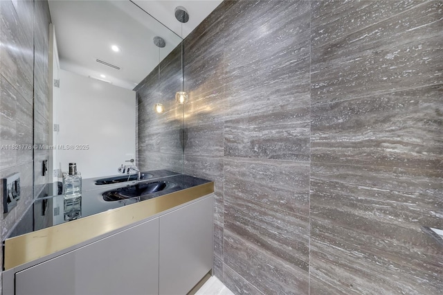300 Collins Ave Unit 3D, Miami Beach, FL 33139 - bathroom featuring vanity and tile walls