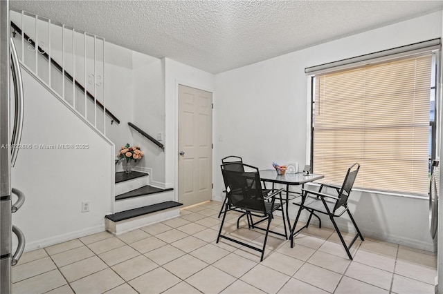 17845 SW 112th Ct, Miami, FL 33157 - dining room with a textured ceiling, stairway, light tile patterned flooring, and plenty of natural light