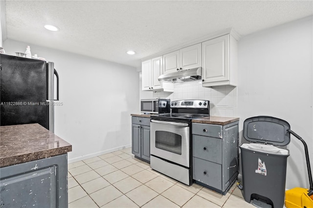 17845 SW 112th Ct, Miami, FL 33157 - kitchen with appliances with stainless steel finishes, under cabinet range hood, white cabinetry, dark countertops, and a textured ceiling