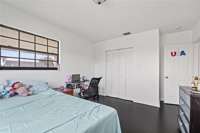 17845 SW 112th Ct, Miami, FL 33157 - bedroom featuring a textured ceiling, a closet, and dark wood-type flooring