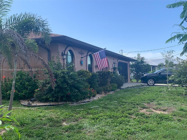 30 Bunker Ln Fl, Grove City-Rotonda, FL 33947 - view of side of property with a lawn and stucco siding