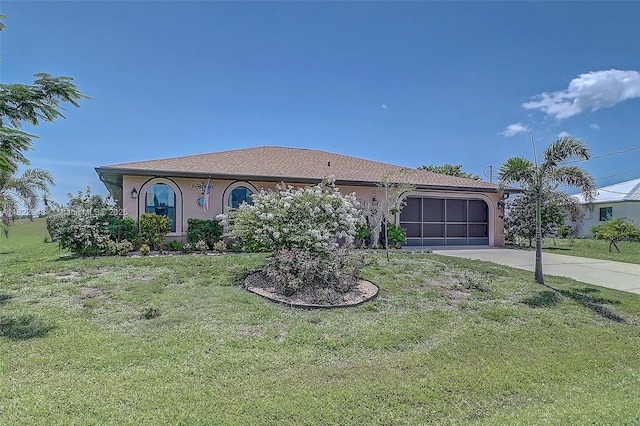 30 Bunker Ln Fl, Grove City-Rotonda, FL 33947 - view of front of house featuring a garage, concrete driveway, stucco siding, and a front yard
