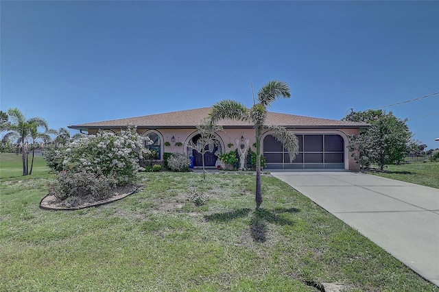 30 Bunker Ln Fl, Grove City-Rotonda, FL 33947 - view of front of house featuring a garage, concrete driveway, stucco siding, and a front yard