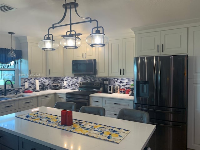 30 Bunker Ln Fl, Grove City-Rotonda, FL 33947 - kitchen with refrigerator with ice dispenser, electric range oven, light countertops, decorative backsplash, and a center island