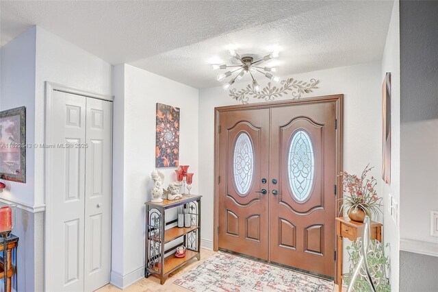 30 Bunker Ln Fl, Grove City-Rotonda, FL 33947 - foyer entrance featuring a textured ceiling and french doors