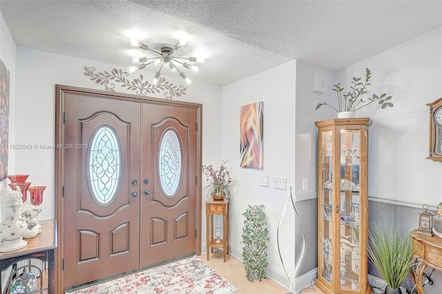 30 Bunker Ln Fl, Grove City-Rotonda, FL 33947 - foyer featuring a textured ceiling, a chandelier, and french doors