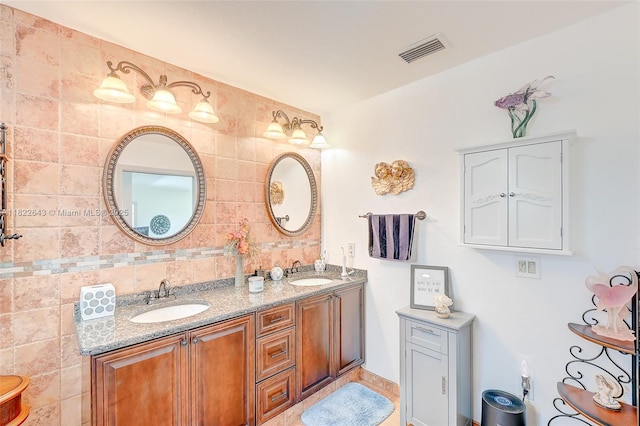 30 Bunker Ln Fl, Grove City-Rotonda, FL 33947 - bathroom with double vanity and backsplash