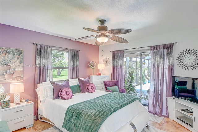 30 Bunker Ln Fl, Grove City-Rotonda, FL 33947 - bedroom featuring access to exterior, multiple windows, a textured ceiling, and a ceiling fan