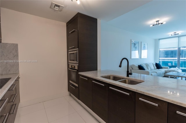 900 Biscayne Blvd Unit 2210, Miami, FL 33132 - kitchen featuring stainless steel appliances, light stone counters, open floor plan, light tile patterned flooring, and modern cabinets