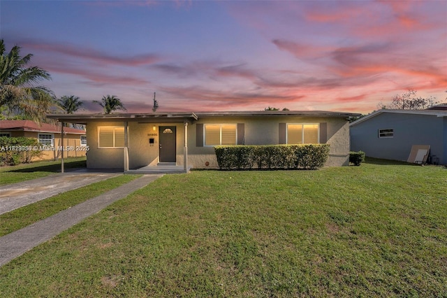 19801 NE 1st Ave, Miami, FL 33179 - ranch-style home featuring stucco siding, a front yard, and concrete driveway