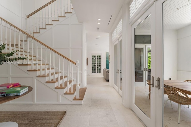 220 Cypress Dr, Key Biscayne, FL 33149 - entrance foyer with french doors, stairs, and a decorative wall