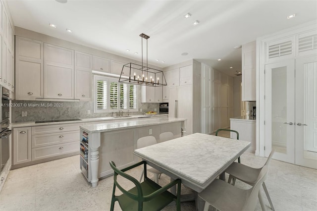 220 Cypress Dr, Key Biscayne, FL 33149 - kitchen featuring a kitchen island, a chandelier, backsplash, recessed lighting, and hanging light fixtures