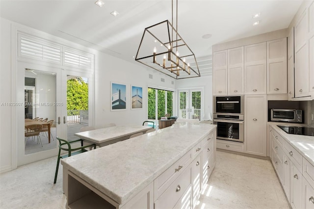 220 Cypress Dr, Key Biscayne, FL 33149 - kitchen featuring black electric stovetop, a center island, stainless steel double oven, and french doors