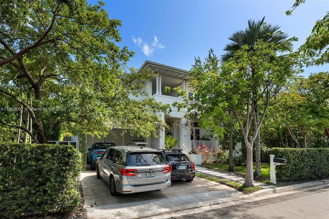 220 Cypress Dr, Key Biscayne, FL 33149 - view of property hidden behind natural elements featuring concrete driveway and stucco siding