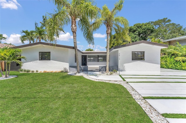 2413 Gulfstream Ln, Fort Lauderdale, FL 33312 - view of front facade with stucco siding and a front yard