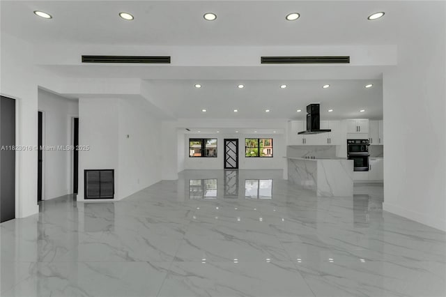 2413 Gulfstream Ln, Fort Lauderdale, FL 33312 - unfurnished living room with recessed lighting and light marble finish floors