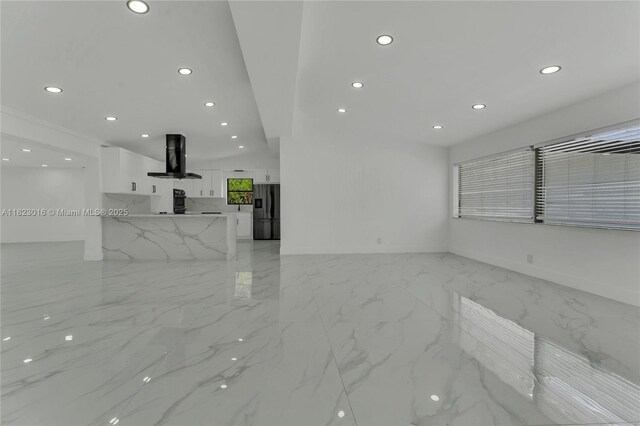 2413 Gulfstream Ln, Fort Lauderdale, FL 33312 - unfurnished living room featuring light marble finish floors and recessed lighting