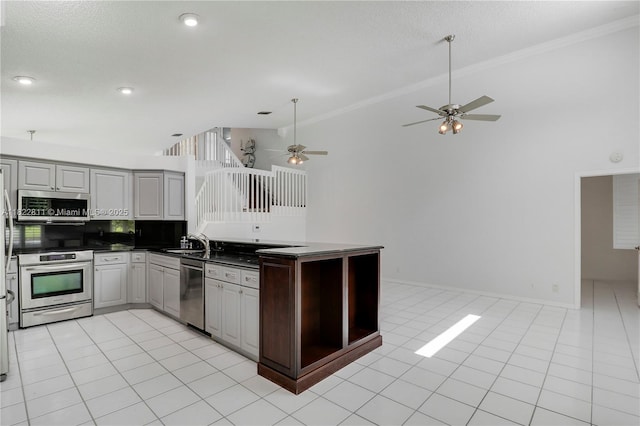 2278 SW Olympic Club Ter, Palm City, FL 34990 - kitchen featuring stainless steel appliances, dark countertops, a ceiling fan, gray cabinets, and ornamental molding