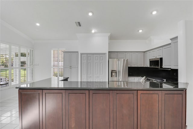 2278 SW Olympic Club Ter, Palm City, FL 34990 - kitchen with appliances with stainless steel finishes, dark countertops, a peninsula, recessed lighting, and crown molding