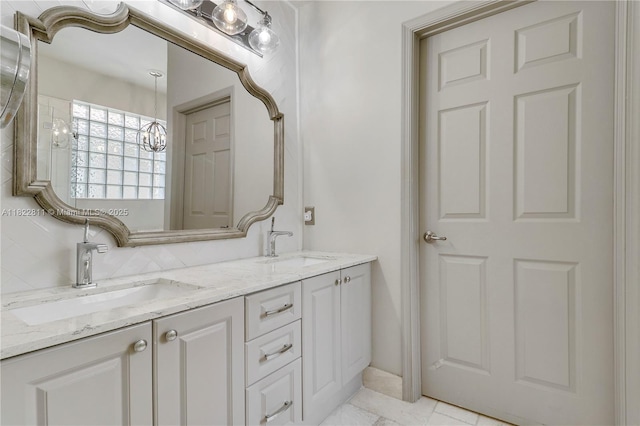 2278 SW Olympic Club Ter, Palm City, FL 34990 - bathroom with double vanity and a chandelier