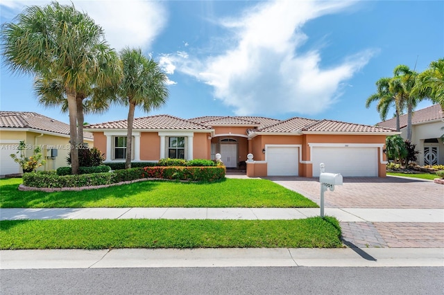 1001 SW 189th Ave, Pembroke Pines, FL 33029 - mediterranean / spanish house with an attached garage, stucco siding, driveway, a front yard, and a tile roof