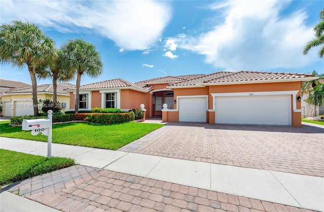 1001 SW 189th Ave, Pembroke Pines, FL 33029 - mediterranean / spanish house with decorative driveway, an attached garage, a front yard, and stucco siding