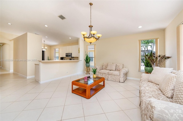 1001 SW 189th Ave, Pembroke Pines, FL 33029 - living room with a chandelier, recessed lighting, light tile patterned flooring, and arched walkways