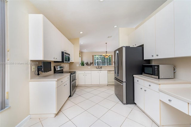 1001 SW 189th Ave, Pembroke Pines, FL 33029 - kitchen with appliances with stainless steel finishes, light countertops, white cabinetry, light tile patterned flooring, and recessed lighting