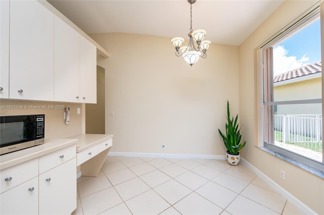 1001 SW 189th Ave, Pembroke Pines, FL 33029 - unfurnished dining area with a chandelier, lofted ceiling, and light tile patterned floors