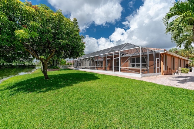 1001 SW 189th Ave, Pembroke Pines, FL 33029 - view of green lawn featuring glass enclosure, a patio, and a water view