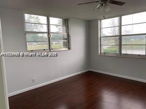 3100 W Rolling Hills Cir Unit 101, Davie, FL 33328 - unfurnished room featuring ceiling fan and wood finished floors