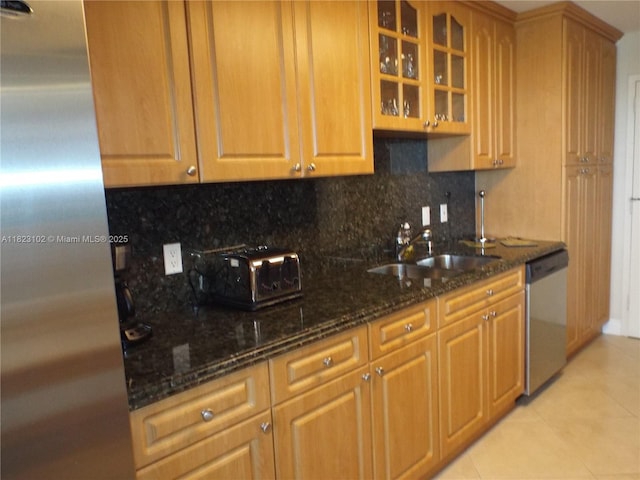 1890 S Ocean Dr Unit 504, Hallandale Beach, FL 33009 - kitchen featuring stainless steel appliances, tasteful backsplash, light tile patterned flooring, and glass insert cabinets