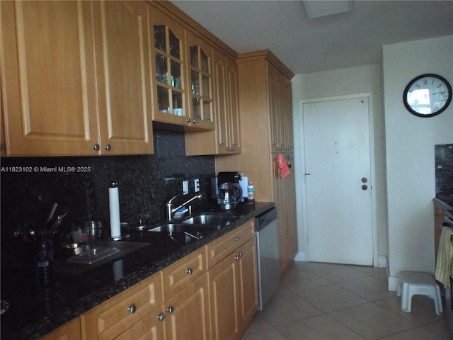 1890 S Ocean Dr Unit 504, Hallandale Beach, FL 33009 - kitchen featuring dishwasher, decorative backsplash, light tile patterned floors, dark stone counters, and glass insert cabinets