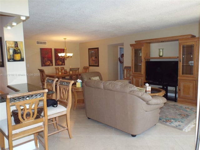 1890 S Ocean Dr Unit 504, Hallandale Beach, FL 33009 - living area featuring a chandelier, a textured ceiling, and light tile patterned floors