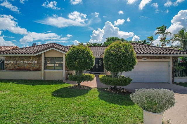 20045 NW 65th Ct, Hialeah, FL 33015 - view of front of home featuring a tiled roof, driveway, an attached garage, and a front yard
