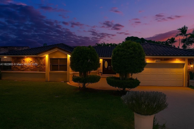 20045 NW 65th Ct, Hialeah, FL 33015 - view of front facade featuring an attached garage, a lawn, a tiled roof, and driveway