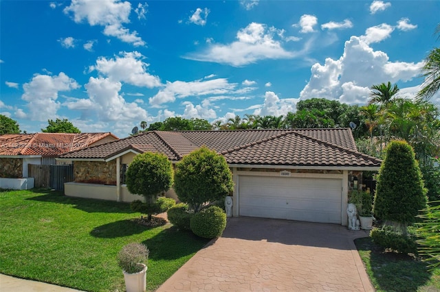 20045 NW 65th Ct, Hialeah, FL 33015 - mediterranean / spanish house with a tile roof, decorative driveway, an attached garage, and stucco siding