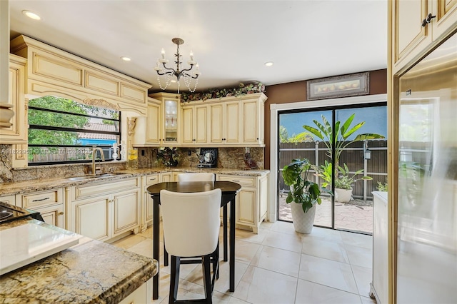 20045 NW 65th Ct, Hialeah, FL 33015 - kitchen with cream cabinetry, built in fridge, a chandelier, decorative backsplash, and recessed lighting