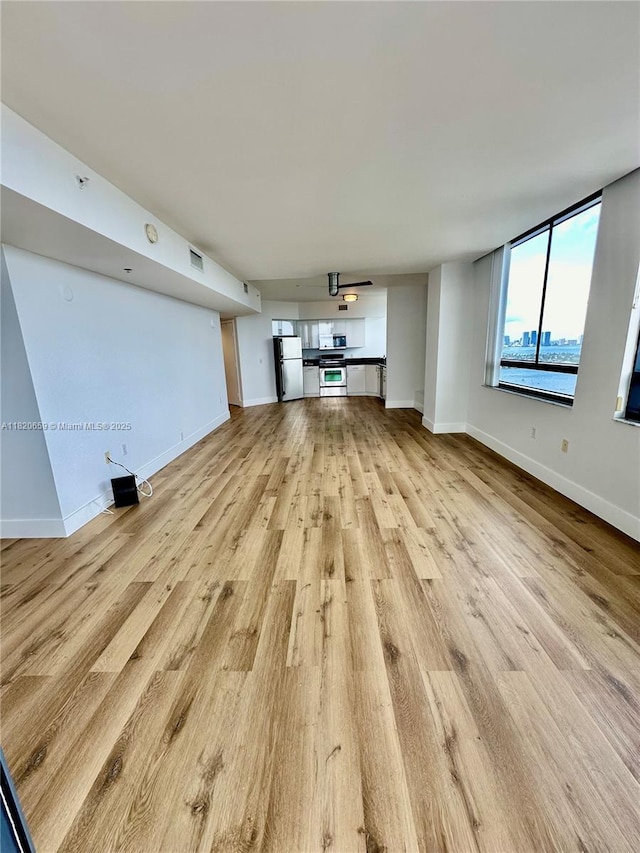 1330 W Ave Unit 3007, Miami Beach, FL 33139 - unfurnished living room with light wood finished floors and baseboards