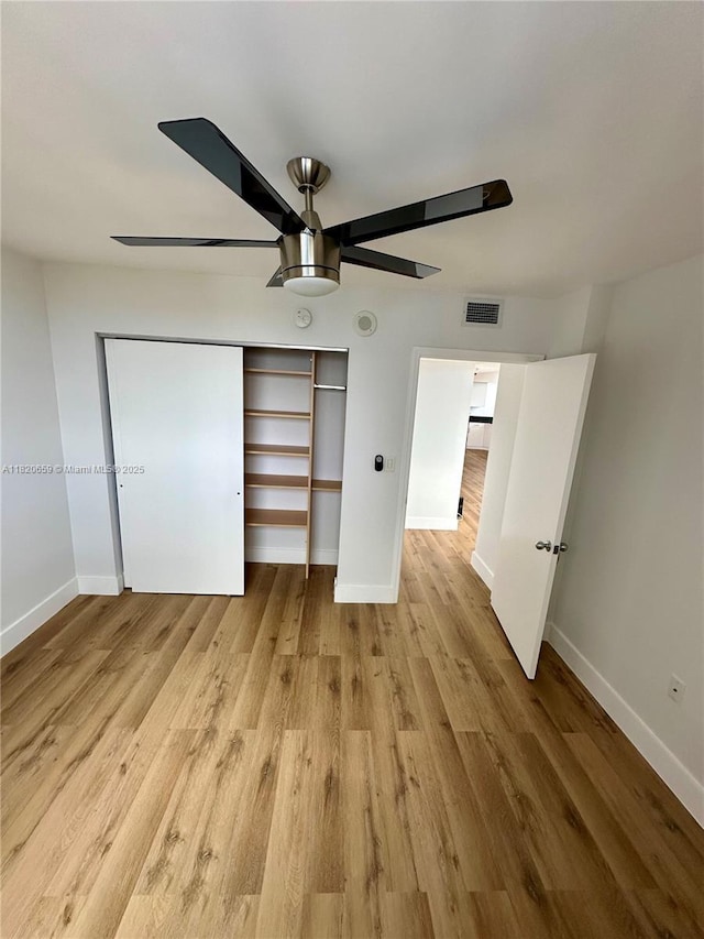 1330 W Ave Unit 3007, Miami Beach, FL 33139 - unfurnished bedroom with a closet, light wood-style floors, and a ceiling fan
