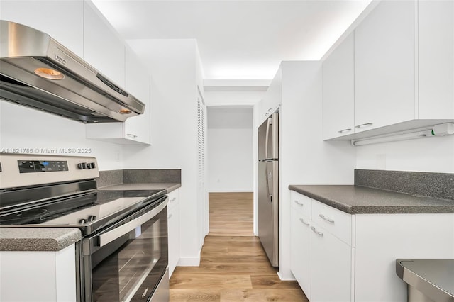8335 SW 72nd Ave Unit 315D, Miami, FL 33143 - kitchen with stainless steel appliances, exhaust hood, dark countertops, light wood-style flooring, and white cabinets