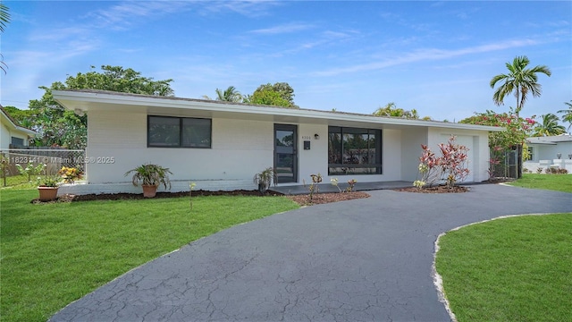 4300 Monroe St, Hollywood, FL 33021 - view of front of house featuring asphalt driveway and a garage