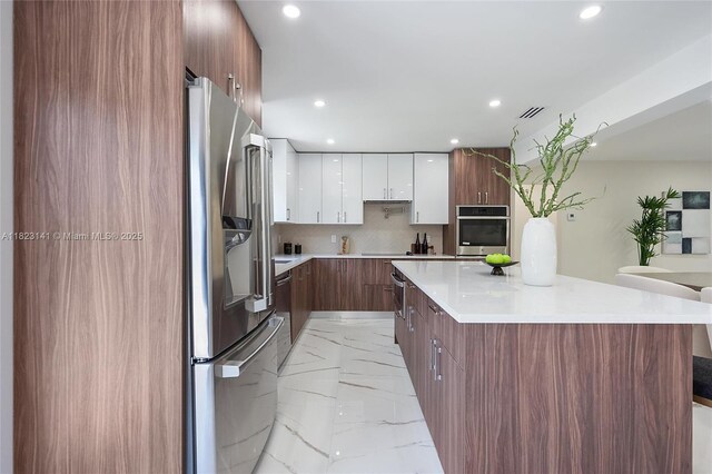 4300 Monroe St, Hollywood, FL 33021 - kitchen featuring stainless steel fridge with ice dispenser, modern cabinets, light marble finish floors, white cabinetry, and recessed lighting