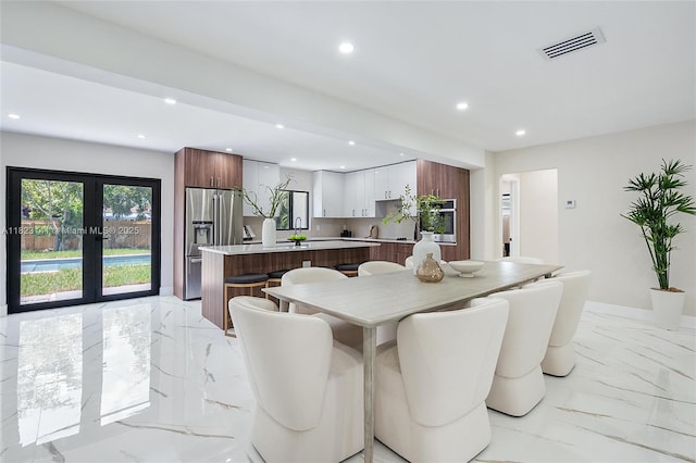 4300 Monroe St, Hollywood, FL 33021 - dining space featuring light marble finish flooring, recessed lighting, and french doors
