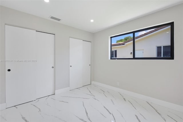 4300 Monroe St, Hollywood, FL 33021 - unfurnished bedroom with multiple closets, recessed lighting, and light marble finish flooring