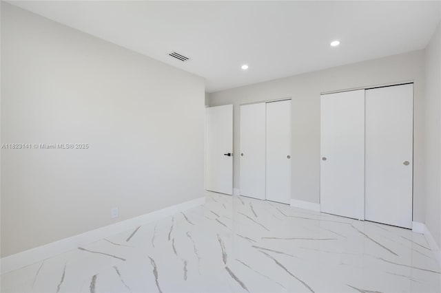 4300 Monroe St, Hollywood, FL 33021 - unfurnished bedroom featuring two closets, recessed lighting, and light marble finish flooring