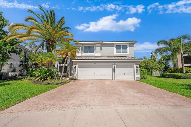 2631 SW 180th Ave, Miramar, FL 33029 - view of front of property featuring stucco siding, a standing seam roof, decorative driveway, an attached garage, and a front yard