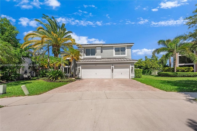 2631 SW 180th Ave, Miramar, FL 33029 - view of front of home with a standing seam roof, an attached garage, stucco siding, concrete driveway, and a front yard