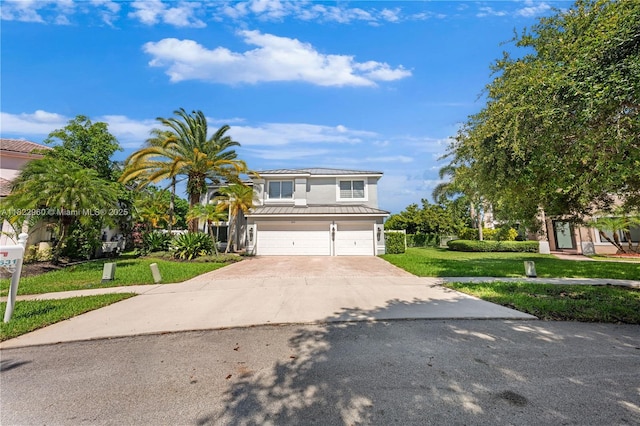 2631 SW 180th Ave, Miramar, FL 33029 - view of front facade featuring an attached garage, concrete driveway, a standing seam roof, a front lawn, and a metal roof