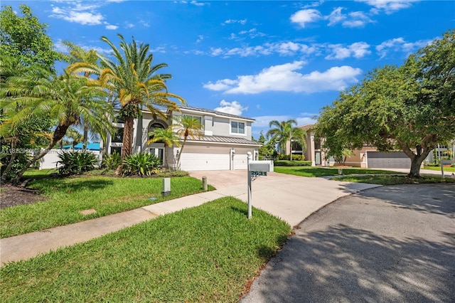 2631 SW 180th Ave, Miramar, FL 33029 - view of front of property featuring driveway, an attached garage, stucco siding, a front yard, and a standing seam roof